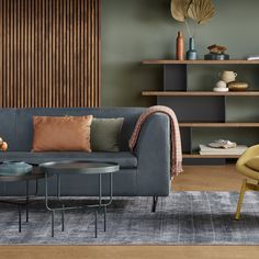 a living room scene with focus on the couch and coffee table in the foreground