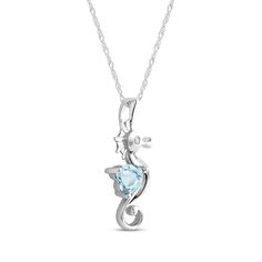 a necklace with a seahorse on it and a blue crystal stone in the center