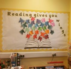 a bulletin board with butterflies on it and reading give you wings written above the book