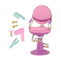 a pink chair with scissors and combs next to it on top of a white surface