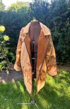 This cozy upcycled vintage blanket coat is great for fall and winter.  Made from a vintage wool blanket that is a beautiful camel colour with dark caramel brown floral details. it will keep you warm during the cooler months.  Two toggle closures allow for it to be worn closed, or leave it open for a more relaxed look. This coat is an oversized fit and can be worn by sizes small to large.  Laying flat the pit to pit measurement is 20 inches.  Model typically wears size medium. Vintage Upcycling, Vintage Wool Blanket, Dark Caramel, Blanket Coat, Vintage Blanket, Caramel Brown, The Pit, Camel Color, Brown Floral