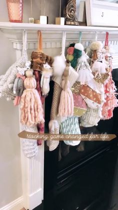 a fireplace mantle filled with lots of different types of stuffed animals hanging from it's sides