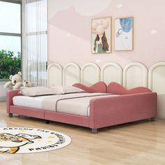 a bedroom with pink walls and white bedding on the floor, along with a teddy bear rug