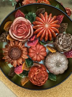 an arrangement of dried flowers on a plate