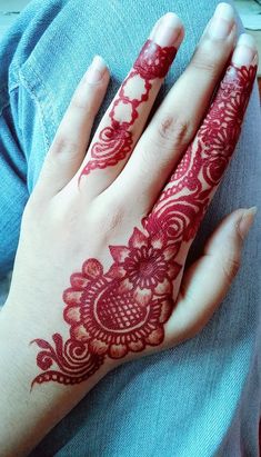 a woman's hand with henna tattoos on it