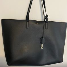 Cut From Supple Leather, This Shopping Tote Is A Classic Essential To Store All Essentials. One Of My Favorite Bags To Bring To Work. Fits A Laptop Perfectly. Very Good Condition. Comes With Dust Bag And Small Leather Good. Measurements: 14.5"W X 11"H X 5"D Dual Top Handle, 9.25" Drop Work Fits, Saint Laurent Bags, Yves Saint Laurent Bags, Shopping Tote, Small Leather Goods, Top Handle, Yves Saint Laurent, Saint Laurent, Dust Bag