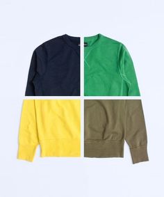 three different colors of sweaters sitting on top of each other in front of a white background