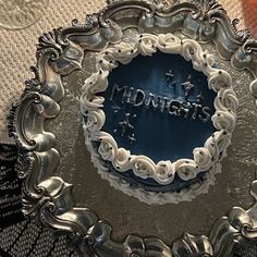 there is a silver plate that has the word midnight on it and stars in the middle