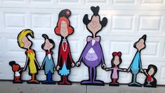 a group of cartoon characters standing in front of a garage door