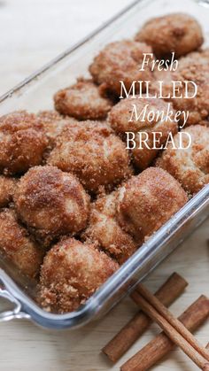 fresh milled monkey bread in a glass dish with cinnamon sticks and cinnamon stick on the side