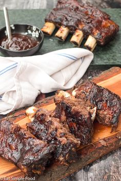 barbecue ribs on a cutting board with bbq sauce