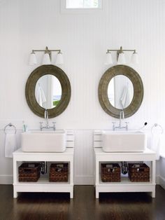 two sinks in a bathroom with mirrors above them