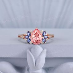 a pink ring with blue and white stones