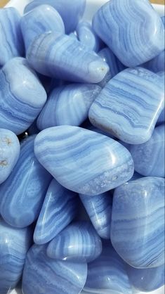 some blue marbles in a white bowl on a table