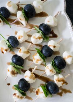 small skewered food items on a white plate