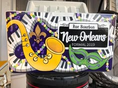 a new orleans mardi gras sign on top of a trash can