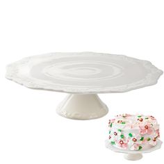 a cake sitting on top of a white plate next to a piece of cake with sprinkles