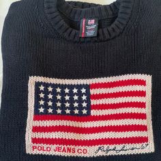 Show Off Your Patriotism With This Polo Ralph Lauren Men's Sweater In Xxl/Ttg Size. The Navy Blue Color And Solid Pattern Make It A Classic Piece To Wear During The Fourth Of July Or Any Occasion. The Long Sleeve Crew Neck Design, Made Of A Comfortable Cotton And Wool Blend Knit Fabric, Features The Iconic American Flag Character. This Vintage Sweater Is Perfect For Men Who Want To Add A Touch Of Classic Style To Their Wardrobe. The Heavyweight And Stretch Features Of The Sweater Ensure A Comfor Designer Ralph Lauren, Polo Ralph Lauren Sweater, Blue Knit Sweater, Ralph Lauren Logo, Vintage Polo Ralph Lauren, Hand Knitted Sweaters, Cotton Pullover, Knitwear Men, Ralph Lauren Sweater