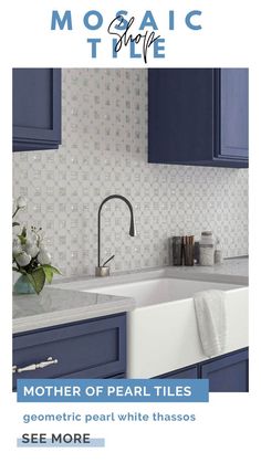 a white sink sitting under a faucet next to a kitchen counter with blue cabinets