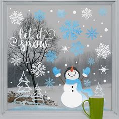 a frosty window with a snowman and tree in the background that says let it snow