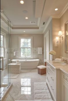 a large bathroom with marble floors and white fixtures