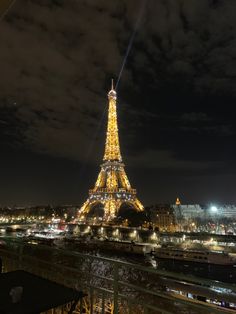 the eiffel tower is lit up at night