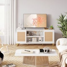 a flat screen tv sitting on top of a white entertainment center