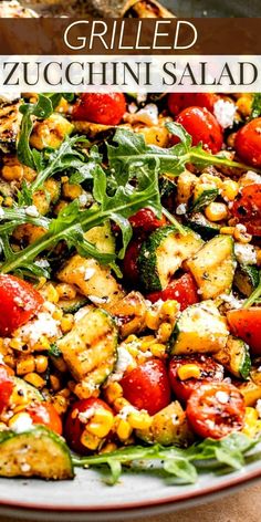 grilled zucchini salad with tomatoes, corn and spinach on a plate