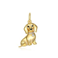 a gold dog charm on a white background