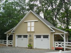 a two car garage is shown in front of a white fence