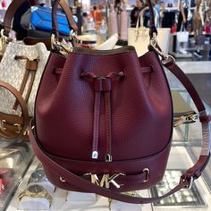 Michael Kors Reed Medium Pebbled Leather Bucket Bag Dark Cherry Nwt New With The Tag Authentic The Reed Infuses Glamor Into An Otherwise Austere Bucket Bag Design. Crafted From Smooth Leather, It Features A Drawstring Closure That Opens To A Spacious Interior. A Belted Feature With Our Gold-Tone “Mk” Hardware And Coordinating Accents Finish It With A Gilded Touch. Carry It By The Top Handle Or Wear It Crossbody With The Removable Strap. Bucket Bag Pebbled Leather 100% Leather Trim: 60% Polyureth Brown Satchel, Embossed Bag, Michael Kors Satchel, Black Leather Satchel, Satchel Tote Bag, Bag Dark, Leather Satchel Bag, Black Leather Tote, Leather Bucket Bag