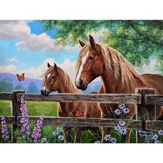 two brown horses standing next to each other on a lush green field with purple flowers