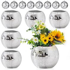 a vase filled with lots of flowers next to many disco ball decorations on a white background