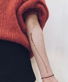 a person with a small tattoo on their arm and the word instagram written in black ink