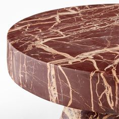 a round marble table with brown veining on it