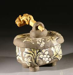 an ornately decorated box with a golden handle