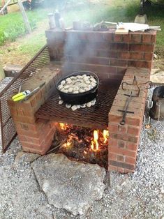 an outdoor bbq grill with hot coals cooking on it's fire pit