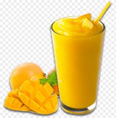 a glass filled with orange juice next to sliced mangoes and an orange on the side