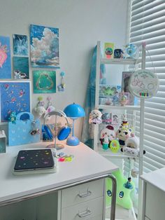 a white desk topped with lots of pictures and toys