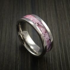 a wedding ring with flowers painted on the inside and inlays to make it stand out