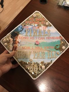 someone is holding up a decorated graduation cap