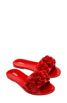 Whimsical floral appliqués bloom boldly atop the strap of a flexible slide sandal crafted from signature fruit-scented PVC. Water-resistant MELFLEX™ PVC is durable, flexible, hypoallergenic and recyclable Synthetic upper, lining and sole Made in Brazil Red Slides For Spring Vacation, Red Flat Slides For Spring, Women Slides, Red Sandals, White Sandals, Slide Sandals, Spring Time, Womens Sandals, Red And White