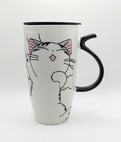 a black and white coffee mug with a cat design on it's side, sitting in front of a white background