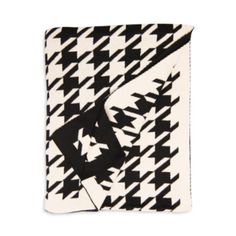 the black and white houndskin pattern is folded on top of a square scarf,