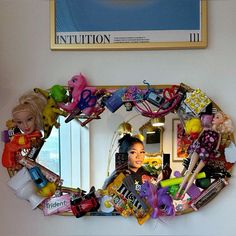 there is a mirror with barbie dolls on it in the shape of a circle, surrounded by toys