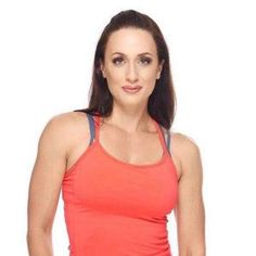 a woman in an orange tank top is posing for the camera with her hands on her hips