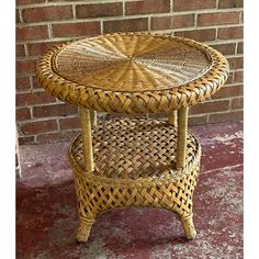 two wicker tables sitting next to each other in front of a brick wall