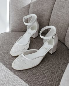 a pair of white shoes sitting on top of a chair