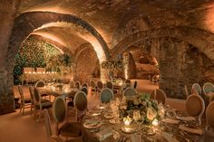 a dining room with tables and chairs set up in an old stone tunnel that has been converted into a restaurant