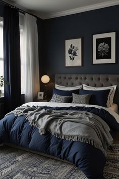 a bedroom with dark blue walls and white curtains